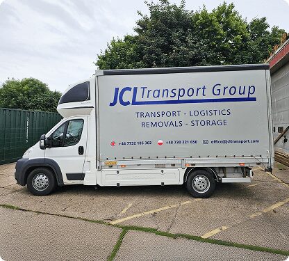 JCL Transport Group curtain-side van parked in the yard